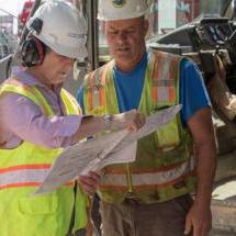 Two construction workers examining the site plan